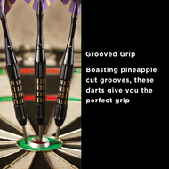 Three black darts with gold grip bands and metal tips in a dartboard bullseye