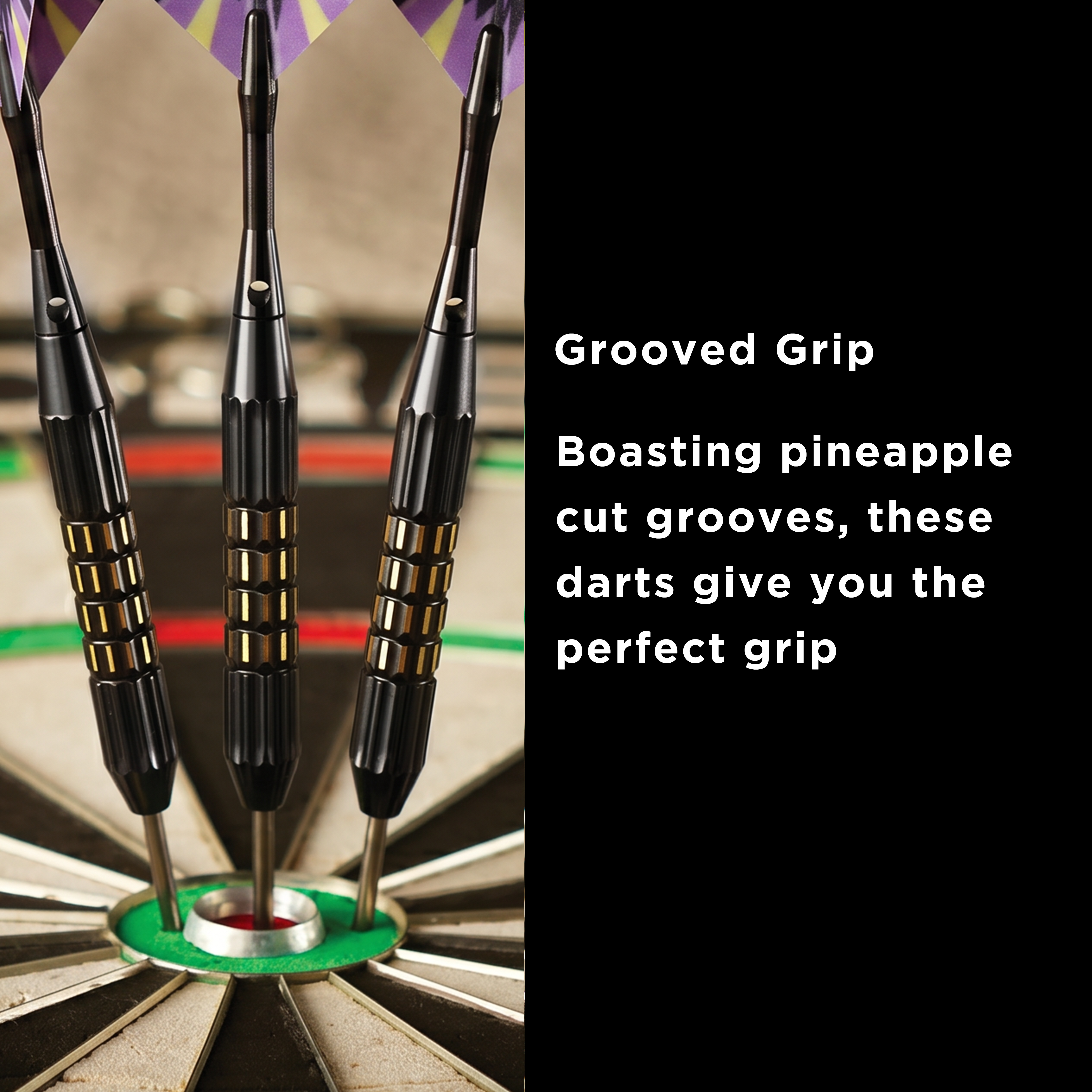 Three black darts with gold grip bands and metal tips in a dartboard bullseye