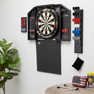 Electronic dartboard mounted on wall with dart storage rack holding red, white, and blue darts