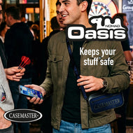 Man at a darts venue holding a phone with a blue Nomad Oasis case worn across his body