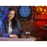 Person opening a red and black dart case at a table with dartboard behind