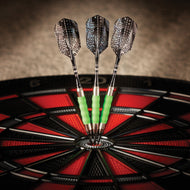 Three darts with green barrels and patterned flights in dartboard bullseye