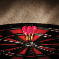Three red darts with white stars and brass stems embedded in a dartboard with red and black segments