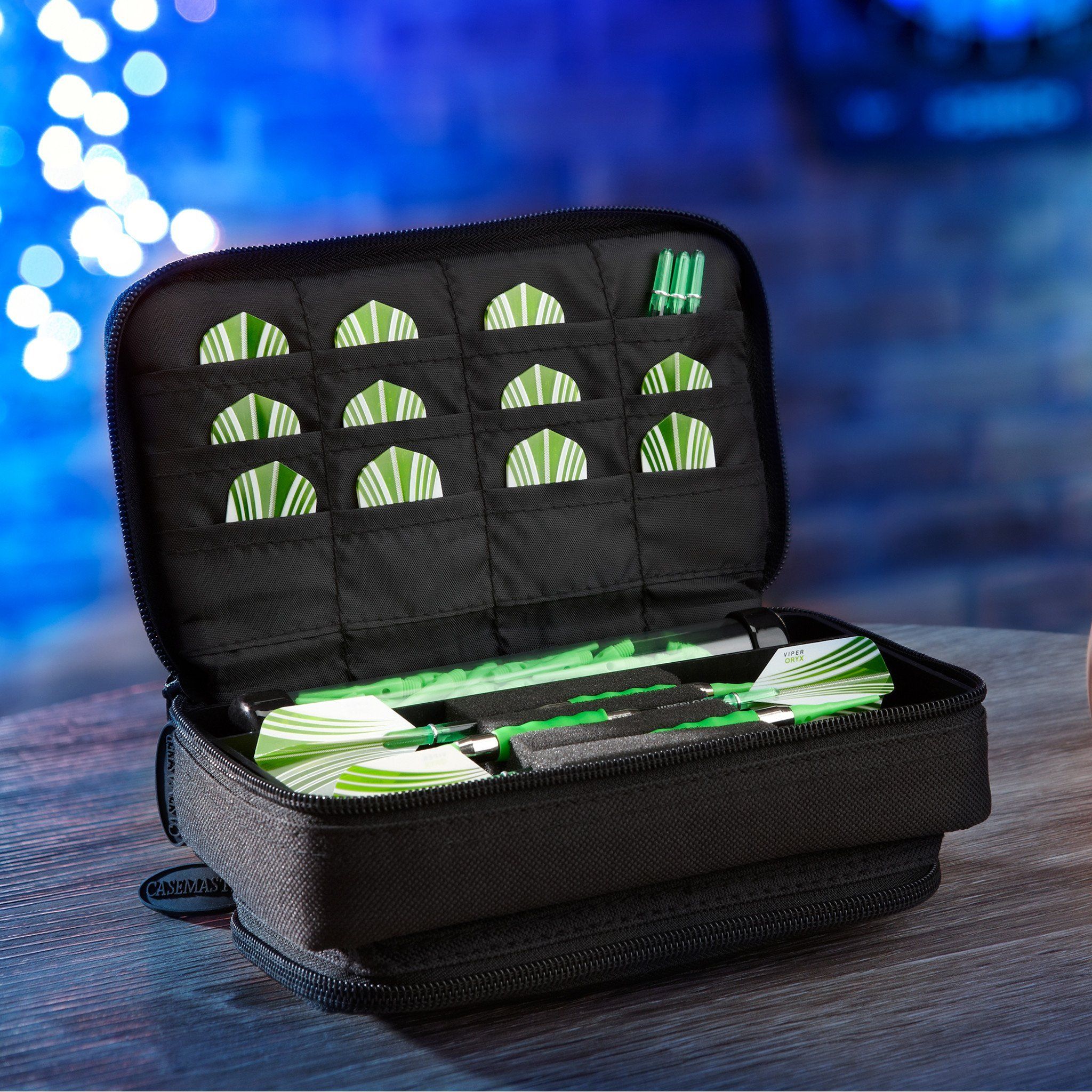 Black dart case open showing green and white striped flights and darts inside