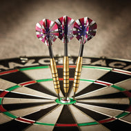Three darts with pink and red flights in dartboard bullseye