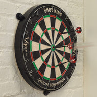 Dartboard with black rim, cream and black wedges, red and green sections, three red darts inserted