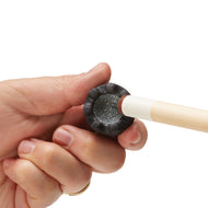 A person's hand holds a cue stick with a light wood shaft and white ferrule, displaying the black textured tip