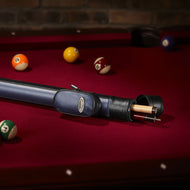 Cue case with blue padded exterior and black carrying strap on red pool table with numbered balls