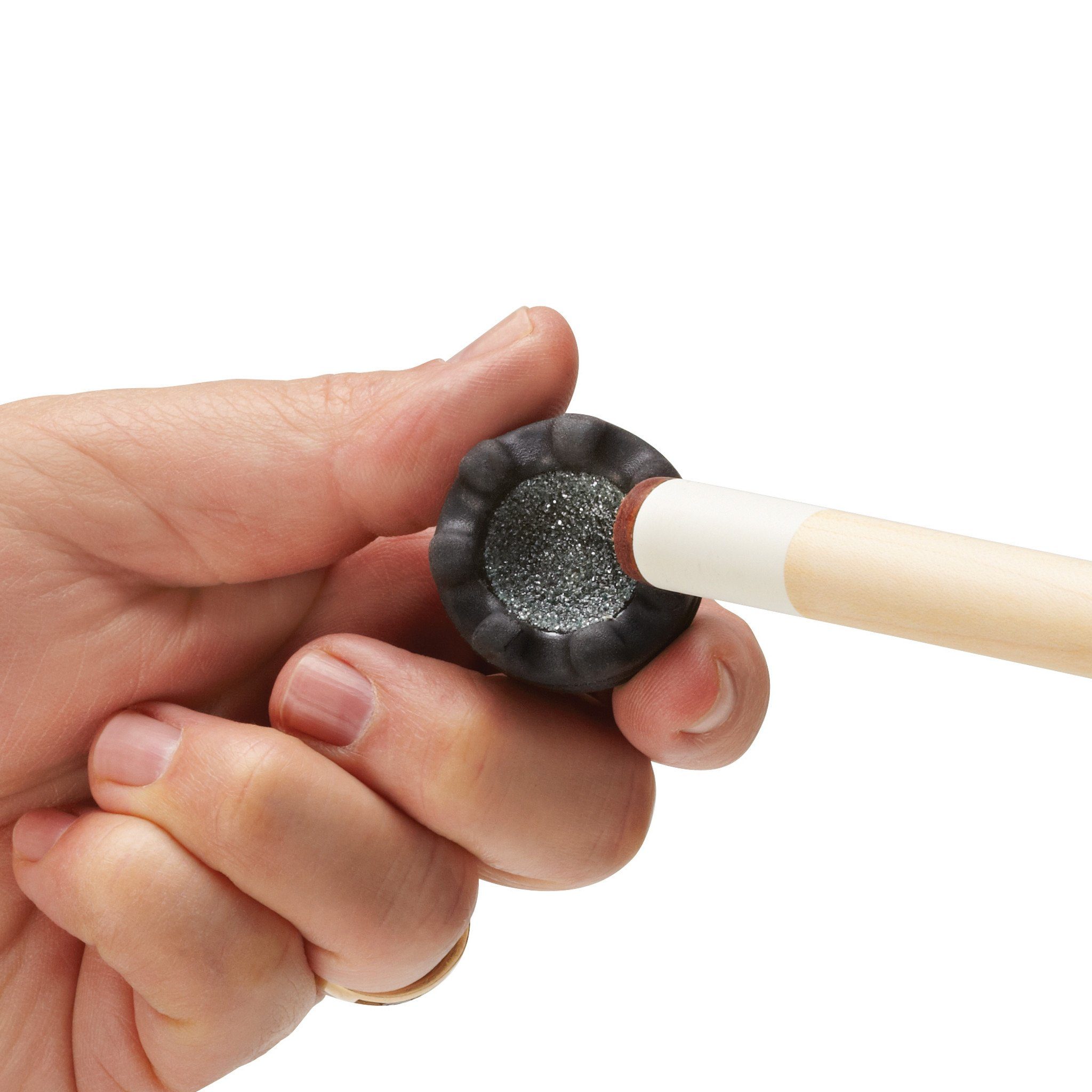 A person holding a cue stick with a black ferrule containing gray chalk dust visible on its tip