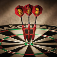 Three red darts with yellow flights in dartboard center bullseye