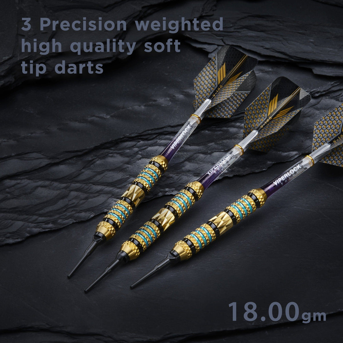 Three soft tip darts with gold barrels and patterned black and gold flights on slate