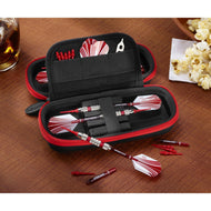 Black dart case with red zipper containing red and white darts, flights, and accessories on wooden surface