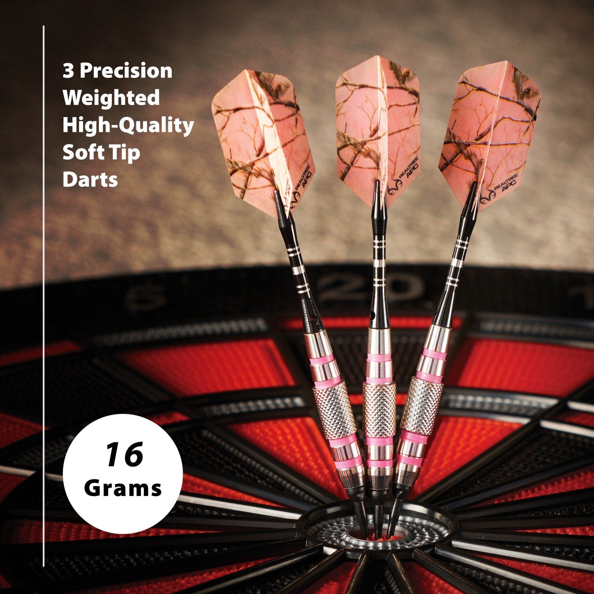 Three soft-tip darts with pink feathered flights and black barrels in a dartboard stand