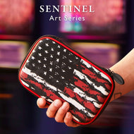 A person's hand holding a black, red, and white distressed flag patterned dart case with red trim and zipper