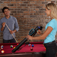 Two people at a billiards table, one holding a cue stick, one holding a black case with blue trim