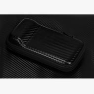 Black zippered dart case with carbon fiber pattern exterior on dark textured background