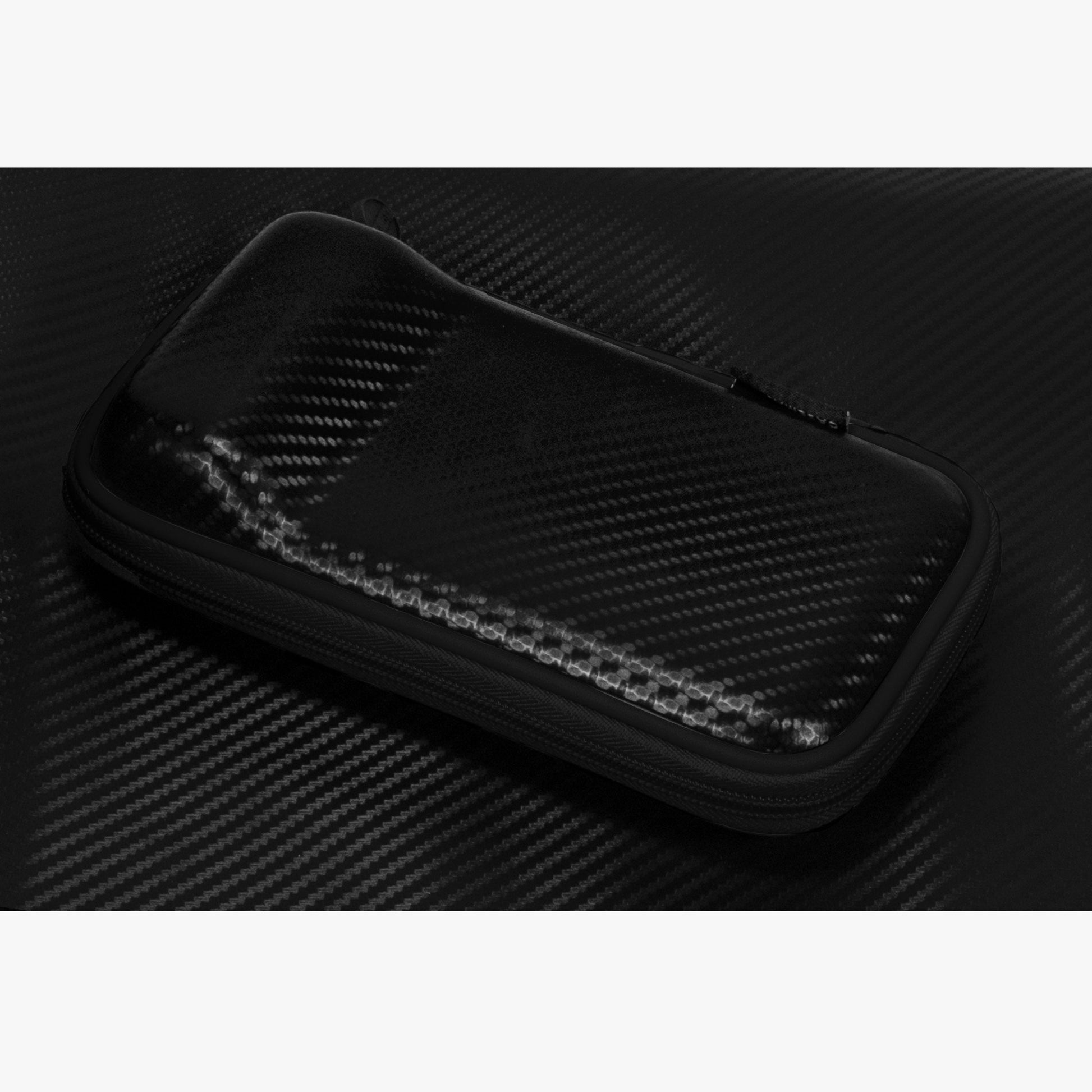 Black zippered dart case with carbon fiber pattern exterior on dark textured background