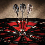 Three darts with red grips in dartboard bullseye