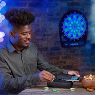 Person holding black dart case with phone pocket at table near illuminated electronic dartboard