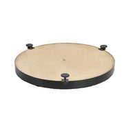 Black circular dartboard leveler with tan surface and three adjustment knobs spaced around the base