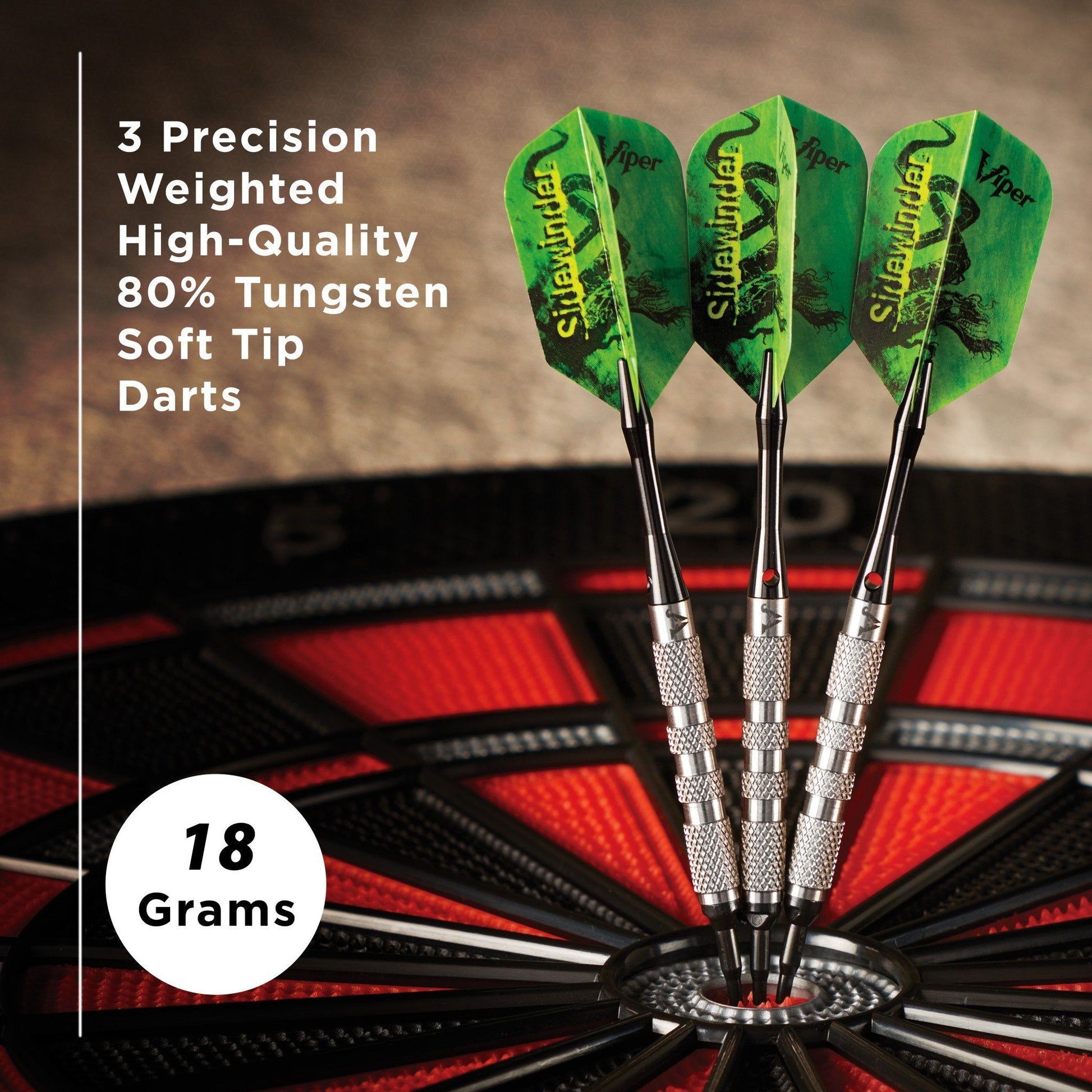 Three green-flight darts with silver barrels and soft tips displayed in a dartboard stand, 18 grams each