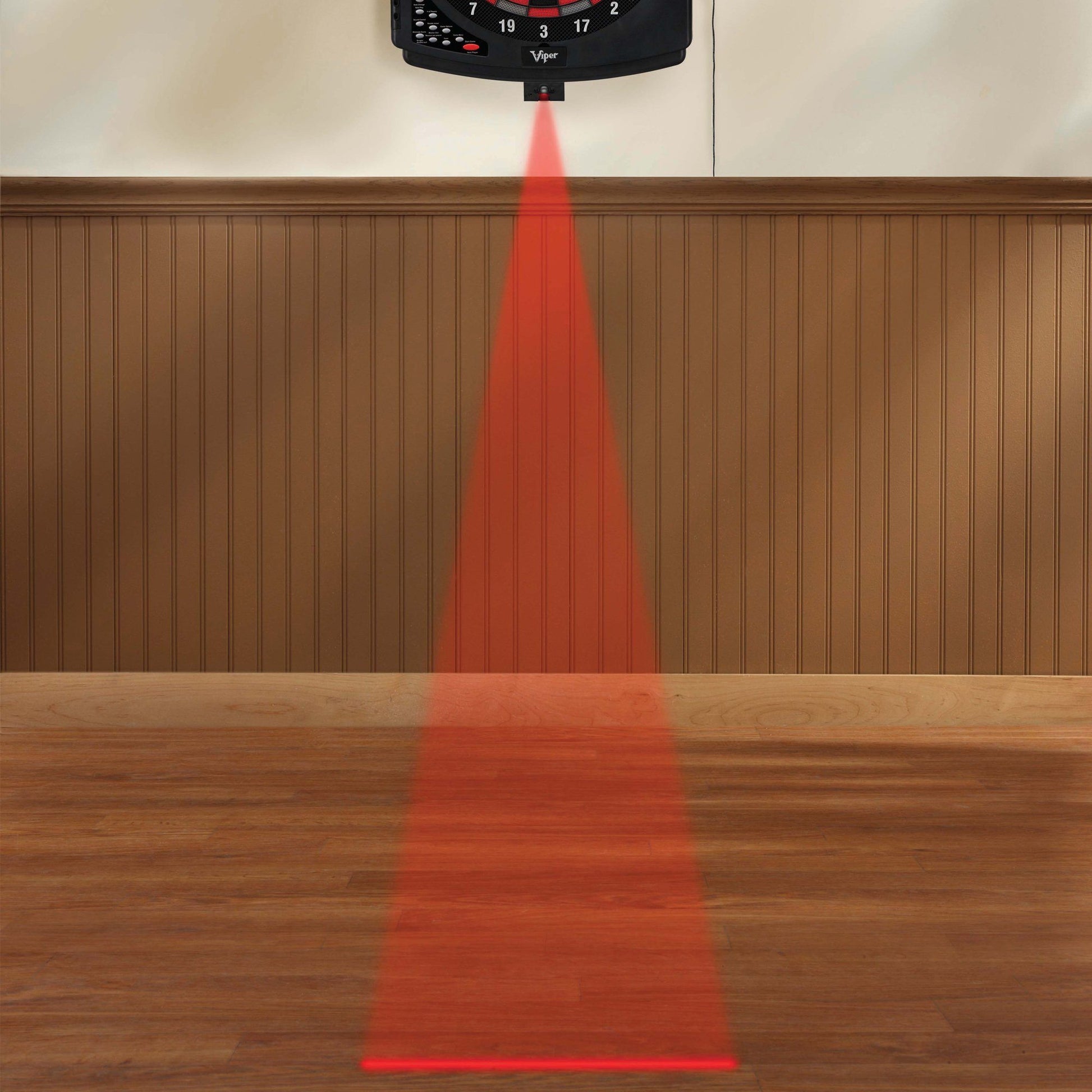 Black Viper dartboard mounted on wall with red laser line projecting downward onto wooden floor