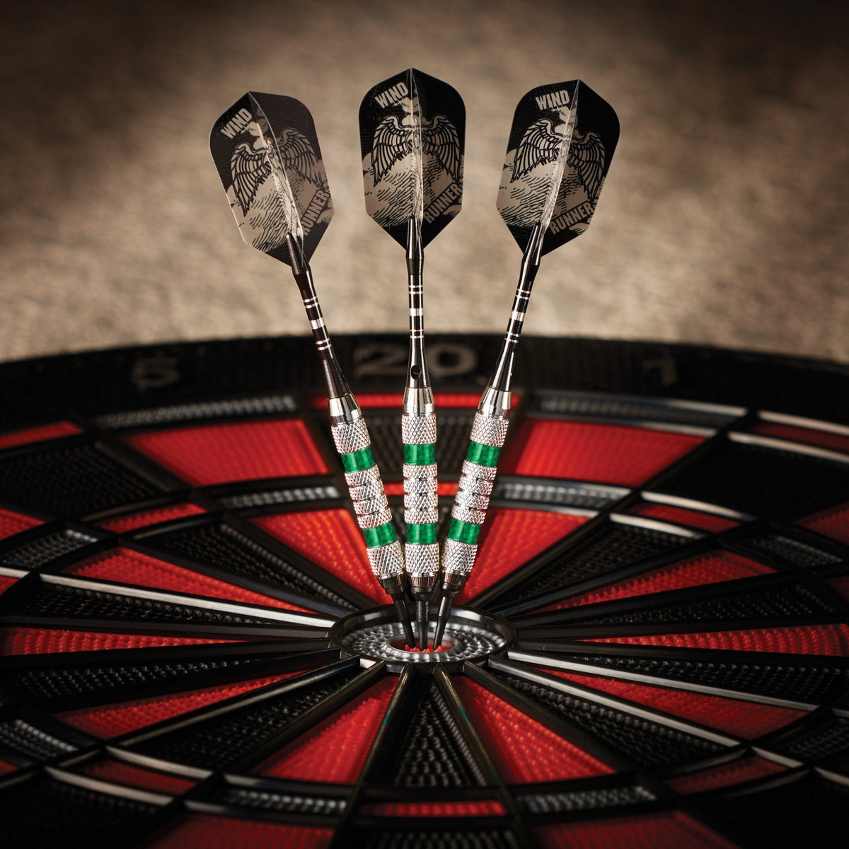 Three black darts with eagle graphics in dartboard bullseye