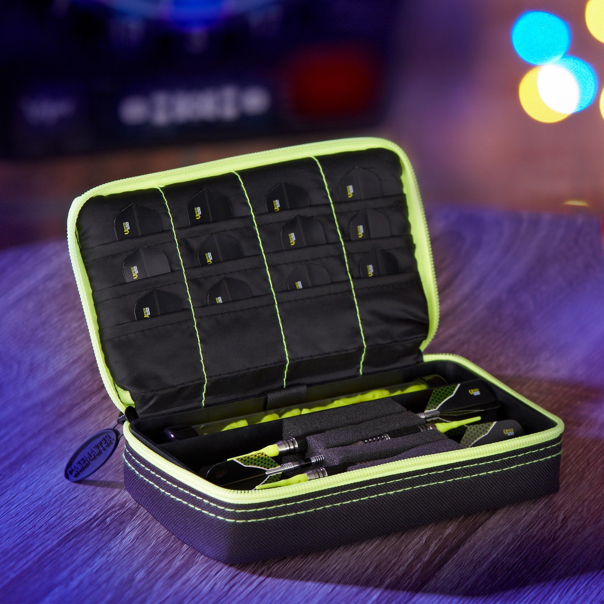 Dart case with yellow trim, black interior compartments, two darts inside