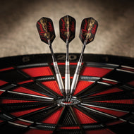 Three darts with black and red flights in a dartboard center