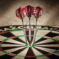 Three red and black darts with textured silver barrels embedded in the center bullseye of a dartboard