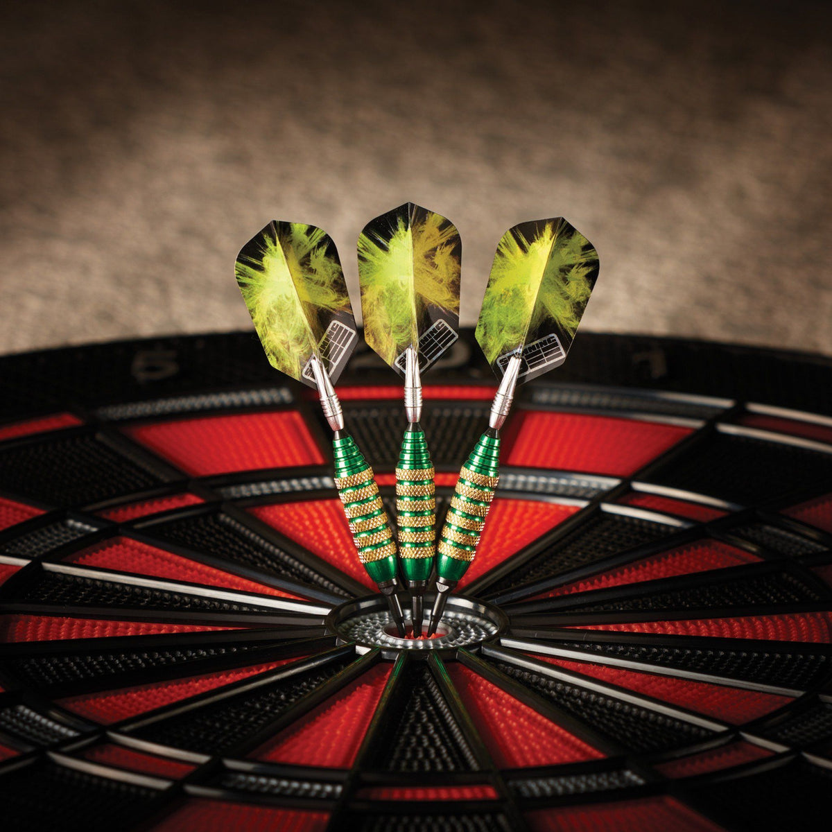 Three darts with yellow flights and green barrels in dartboard bullseye