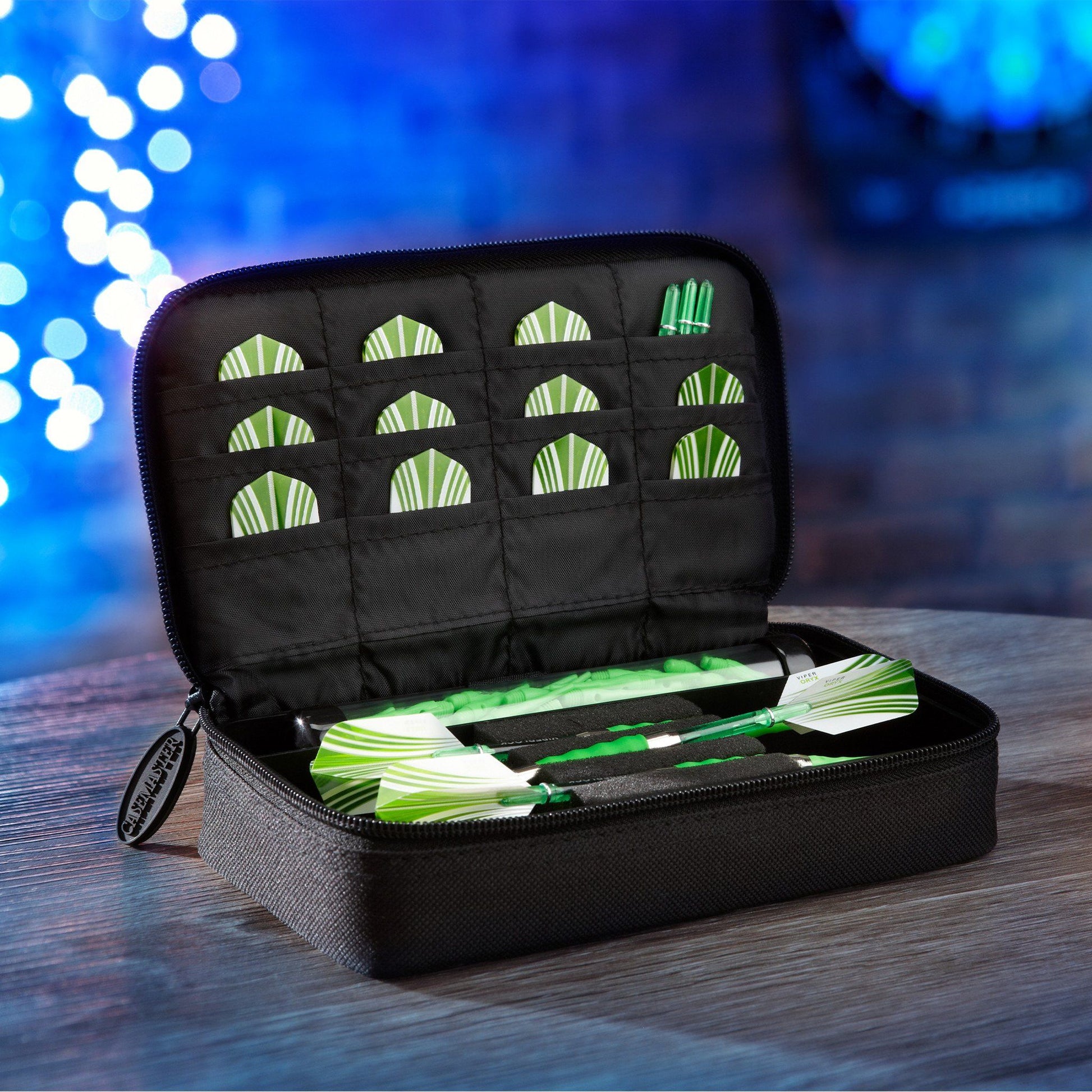 Black dart case with green and white striped darts inside, lid open showing quilted compartments for storage