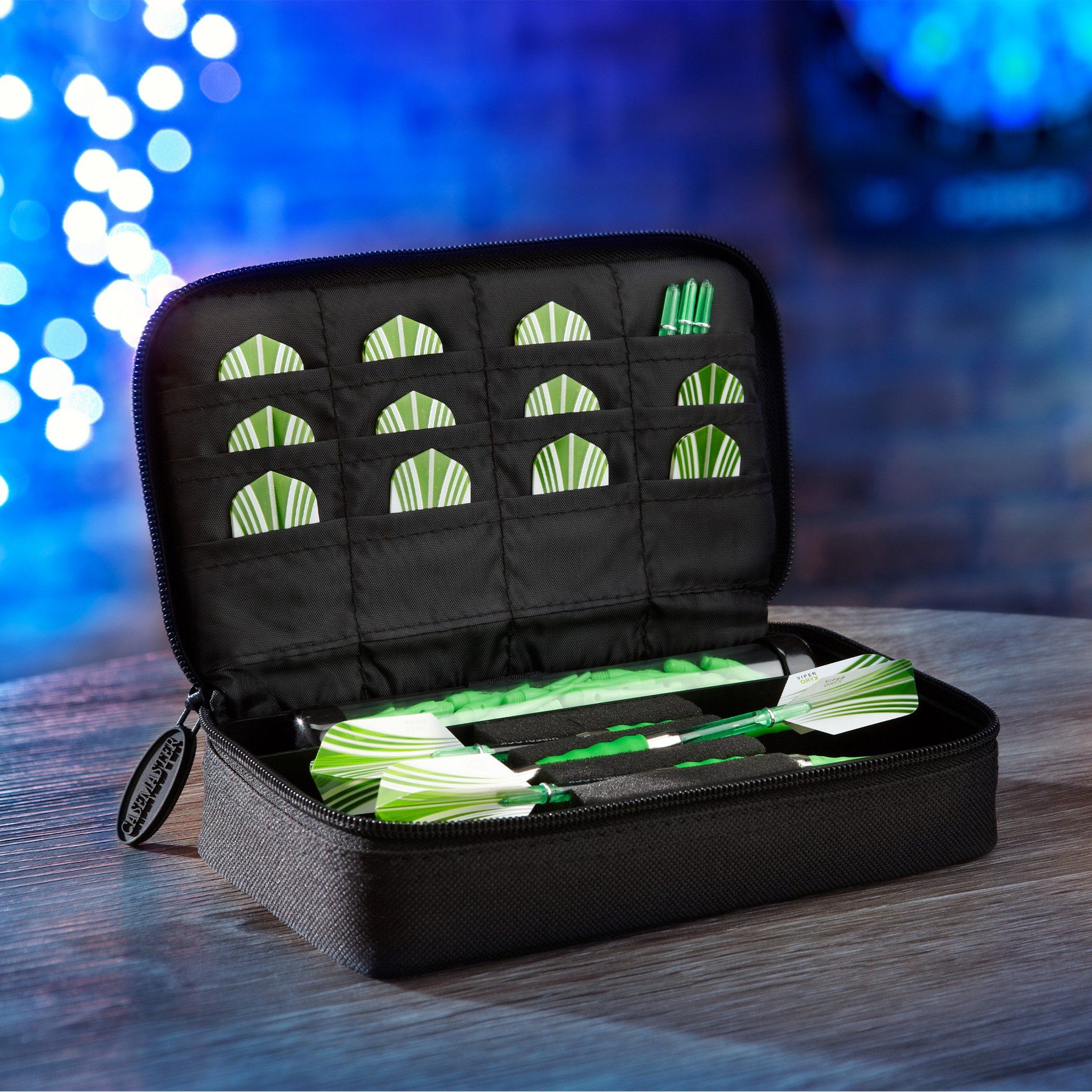 Black dart case with green and white striped darts inside, lid open showing quilted compartments for storage