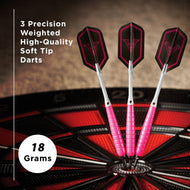 Three soft tip darts with pink wrapping and red flight designs in dartboard stand