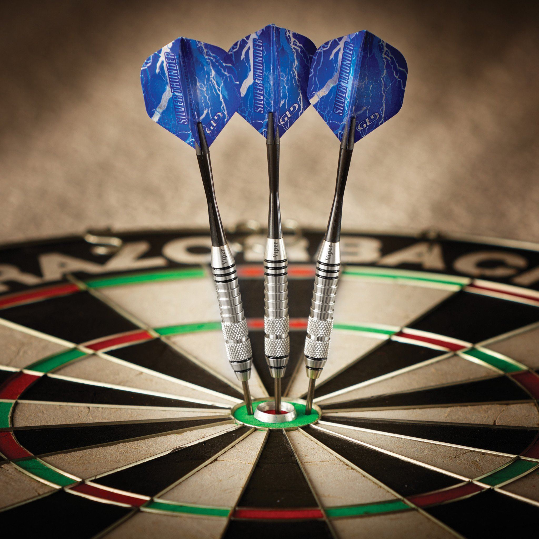 Three blue darts with lightning graphics in dartboard bullseye